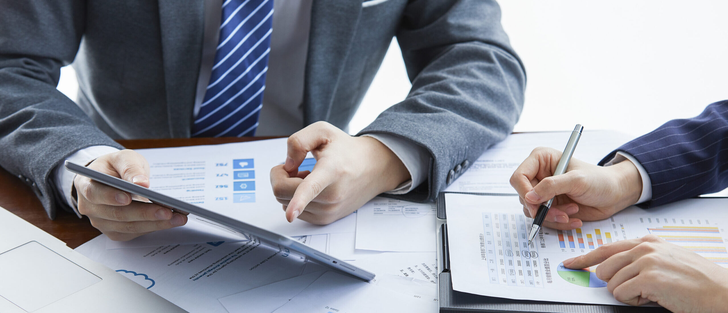 Two businessmen in elegant suits at a business meeting discussing a new project in the office